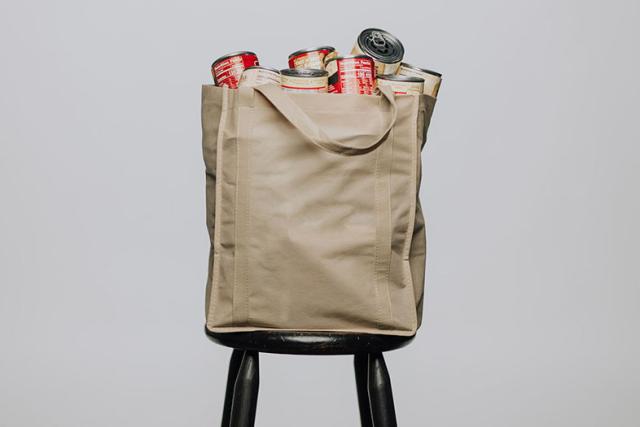 bag of canned good sitting on a chair